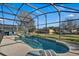 Large screened pool with spa and backyard view at 2661 Emerald Island Blvd, Kissimmee, FL 34747