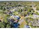 Wide aerial view of a property nestled in a lush, tree-filled neighborhood, highlighting its serene setting and surrounding residences at 280 E Constance Rd, Debary, FL 32713