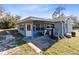 Exterior view of the back of the house with a patio and small outdoor table and chairs at 280 E Constance Rd, Debary, FL 32713