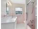 Bathroom with pink tile, a shower/tub combo, and a vanity at 280 E Constance Rd, Debary, FL 32713