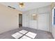 Light-filled bedroom with built-in vanity, closet, carpet flooring, and ceiling fan at 280 E Constance Rd, Debary, FL 32713