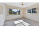 Bedroom with large windows, carpet flooring, and ceiling fan at 280 E Constance Rd, Debary, FL 32713