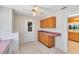 Bright eat-in area featuring desk, ample cabinetry, and door to the backyard at 280 E Constance Rd, Debary, FL 32713