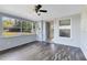 Sunlit Florida room featuring wood-look floors and access to outdoors at 280 E Constance Rd, Debary, FL 32713