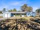 Ranch home with blue exterior, a lawn and a one car garage at 280 E Constance Rd, Debary, FL 32713