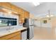 Bright kitchen with stainless steel refrigerator and view into a dining and living area at 280 E Constance Rd, Debary, FL 32713