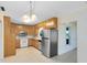 Eat-in kitchen featuring a full appliance package, wood cabinets, ample counterspace and tile flooring at 280 E Constance Rd, Debary, FL 32713