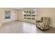 Inviting living room with lots of natural light featuring a floral armchair, tile floor, and neutral wall paint at 280 E Constance Rd, Debary, FL 32713