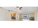 Bright living room features recessed lighting, ceiling fan, neutral walls and tile floor that flows into the adjacent kitchen at 280 E Constance Rd, Debary, FL 32713