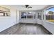 Spacious sunroom featuring wood laminate flooring and large windows overlooking the yard at 280 E Constance Rd, Debary, FL 32713