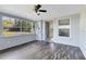 Sunroom with laminate floors, fan, multiple windows and a door to the outside at 280 E Constance Rd, Debary, FL 32713