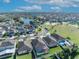 Aerial view showcasing houses, a lake, and green spaces in a residential community at 2950 Sonata Ct, Saint Cloud, FL 34772