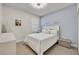 Guest bedroom with a queen bed and light blue accent wall at 2950 Sonata Ct, Saint Cloud, FL 34772