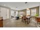 Open concept dining area with a wooden table and view into the living room at 2950 Sonata Ct, Saint Cloud, FL 34772