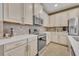 Modern kitchen with white cabinets and stainless steel appliances at 2950 Sonata Ct, Saint Cloud, FL 34772