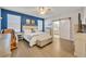 Main bedroom with barn door entry, a king-size bed, and a ceiling fan at 2950 Sonata Ct, Saint Cloud, FL 34772