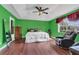 Green bedroom with king bed, recliner, and wood flooring at 2988 Stillwater Dr, Kissimmee, FL 34743