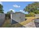 Grey storage shed in backyard with double doors at 2988 Stillwater Dr, Kissimmee, FL 34743