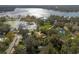 Aerial view showcasing a lakefront property with lush greenery and nearby houses at 332 Lake Winnemissett Dr, Deland, FL 32724