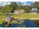 Aerial view of house and pontoon boat by lake at 332 Lake Winnemissett Dr, Deland, FL 32724