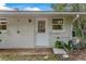 Back exterior showing white brick and a white door at 332 Lake Winnemissett Dr, Deland, FL 32724