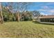 Spacious backyard with large tree and grassy area at 332 Lake Winnemissett Dr, Deland, FL 32724