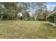 Large grassy backyard with mature trees at 332 Lake Winnemissett Dr, Deland, FL 32724