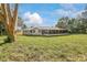 Large backyard with grassy area and mature tree at 332 Lake Winnemissett Dr, Deland, FL 32724