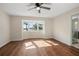 Bedroom with hardwood floors, large window, and backyard view at 332 Lake Winnemissett Dr, Deland, FL 32724