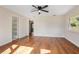 Spacious bedroom featuring hardwood floors and ceiling fan at 332 Lake Winnemissett Dr, Deland, FL 32724