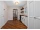 Bright laundry room with washer, dryer, and wood flooring at 332 Lake Winnemissett Dr, Deland, FL 32724