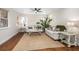 Bright living room with hardwood floors, comfy seating, and large windows at 332 Lake Winnemissett Dr, Deland, FL 32724