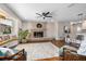 Spacious living room featuring a brick fireplace, hardwood floors, and a built-in window seat at 332 Lake Winnemissett Dr, Deland, FL 32724