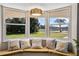 Window seat with a view of the backyard and decorative pillows at 332 Lake Winnemissett Dr, Deland, FL 32724