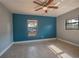 Bedroom with blue accent wall and polished concrete floors at 332 N Lakeland Ave, Orlando, FL 32805