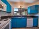 Bright kitchen, featuring blue cabinets and stainless steel appliances at 332 N Lakeland Ave, Orlando, FL 32805