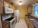 Bright kitchen featuring white appliances and wood cabinets at 335 Brookline Ave, Daytona Beach, FL 32118