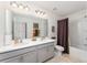 Bright bathroom features double sinks and a bathtub shower combo at 3444 Bellissimo Ave, Kissimmee, FL 34746