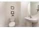 Small half bathroom with pedestal sink and oval mirror at 3444 Bellissimo Ave, Kissimmee, FL 34746