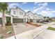 Modern townhouses with attached garages and landscaped yards at 3444 Bellissimo Ave, Kissimmee, FL 34746