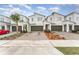 Row of townhouses featuring paver driveways and attractive landscaping at 3444 Bellissimo Ave, Kissimmee, FL 34746