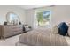 Serene bedroom with large bed, dresser, and window at 3472 Sandalwood Isle Way, Ocoee, FL 34761