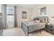 Bright bedroom with metal bed frame, carpet flooring, and large window at 3472 Sandalwood Isle Way, Ocoee, FL 34761