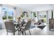 Modern dining area with glass-top table and grey cushioned chairs at 3472 Sandalwood Isle Way, Ocoee, FL 34761