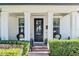 Front entry with black door, brick walkway, and lush landscaping at 3513 Pinetree Rd, Orlando, FL 32804