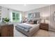 Bright bedroom with a king-size bed and wood-toned furniture at 3522 Sandalwood Isle Way, Ocoee, FL 34761