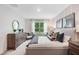 Main bedroom with a king bed, dresser, and window overlooking the backyard at 3522 Sandalwood Isle Way, Ocoee, FL 34761