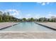 Community pool with a spacious deck and plenty of sunshine at 3522 Sandalwood Isle Way, Ocoee, FL 34761