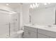 Modern bathroom with double vanity, gray cabinets and shower at 3564 Landing Net Dr, Kissimmee, FL 34746