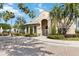 Community clubhouse with palm trees and a brick-paved road at 3564 Landing Net Dr, Kissimmee, FL 34746